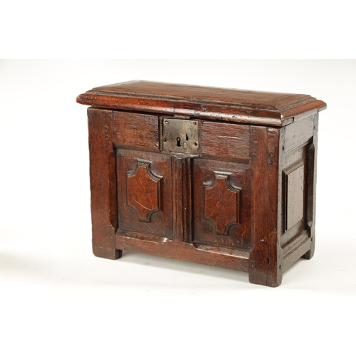 177 - A RARE 17TH CENTURY MINIATURE OAK COFFER with cross-banded moulded top above a double-panelled shape... 