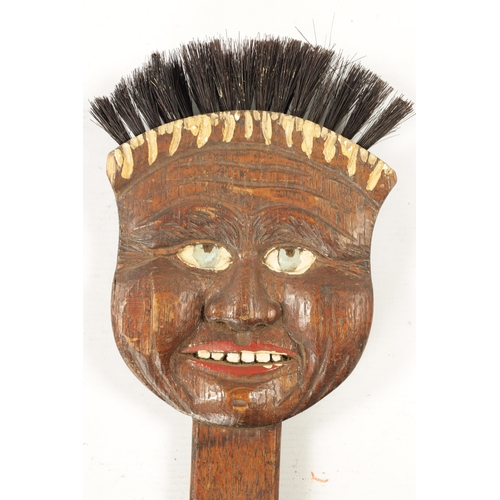 180 - TWO UNUSUAL EARLY 20TH CENTURY CARVED WOOD LONG-HANDLED COMICAL BRUSHES one depicting 'Billikin' (66... 