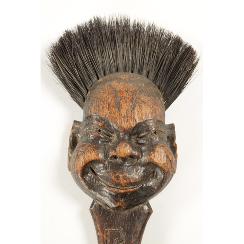 180 - TWO UNUSUAL EARLY 20TH CENTURY CARVED WOOD LONG-HANDLED COMICAL BRUSHES one depicting 'Billikin' (66... 