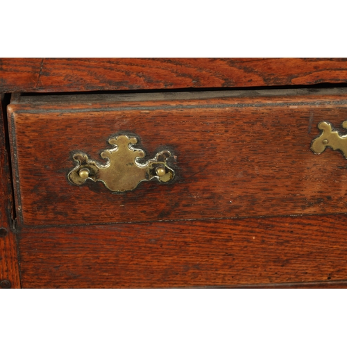 19 - AN EARLY 18TH CENTURY OAK TWO DRAWER DRESSER BASE the plank top above two frieze drawers and two fie... 