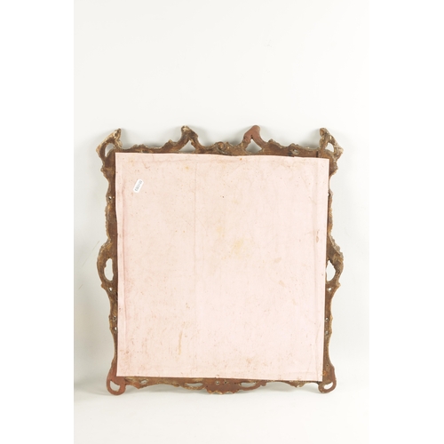 199 - A SMALL EARLY 18TH CENTURY CARVED GILT-WOOD MIRROR with rococo style leaf border (50cm high 46cm wid... 