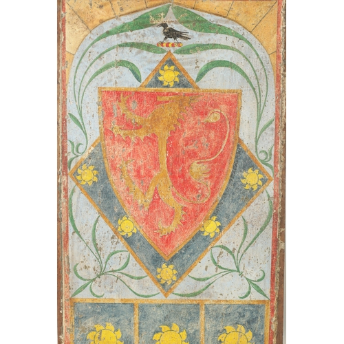 201 - A 17TH CENTURY PAINTED OAK PANEL of a shield above three sun motifs. (51cm high 28.5cm wide)