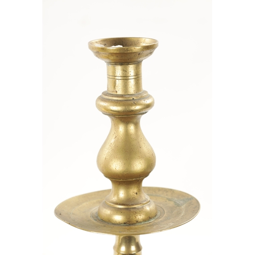 202 - A LARGE PAIR OF 18TH CENTURY BRASS CANDLESTICKS of rippled baluster form and centre drip trays