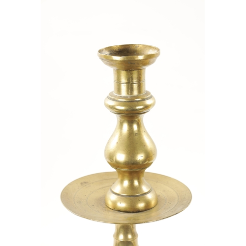 202 - A LARGE PAIR OF 18TH CENTURY BRASS CANDLESTICKS of rippled baluster form and centre drip trays