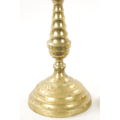 202 - A LARGE PAIR OF 18TH CENTURY BRASS CANDLESTICKS of rippled baluster form and centre drip trays