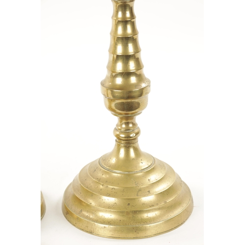 202 - A LARGE PAIR OF 18TH CENTURY BRASS CANDLESTICKS of rippled baluster form and centre drip trays