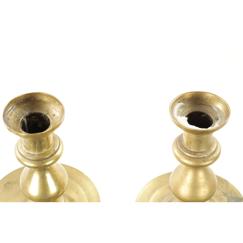 202 - A LARGE PAIR OF 18TH CENTURY BRASS CANDLESTICKS of rippled baluster form and centre drip trays