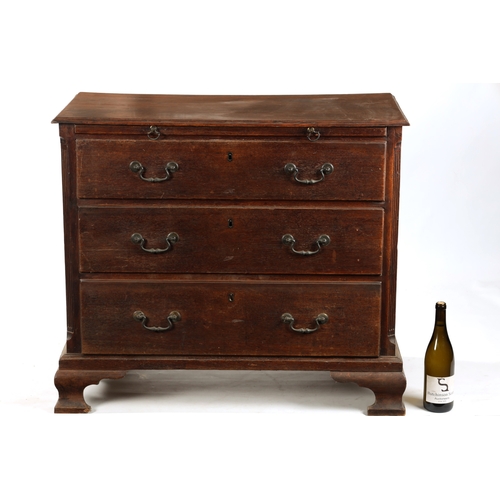 207 - AN 18TH CENTURY COUNTRY HOUSE OAK CHEST OF DRAWERS with brushing slide, fluted canted corners and th... 