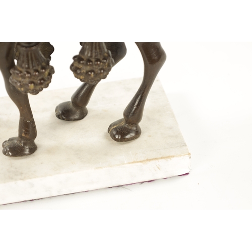 210 - AN EARLY 20TH CENTURY BRONZE SCULPTURE OF A CAMEL mounted on a marble base. (24cm high 21cm wide)