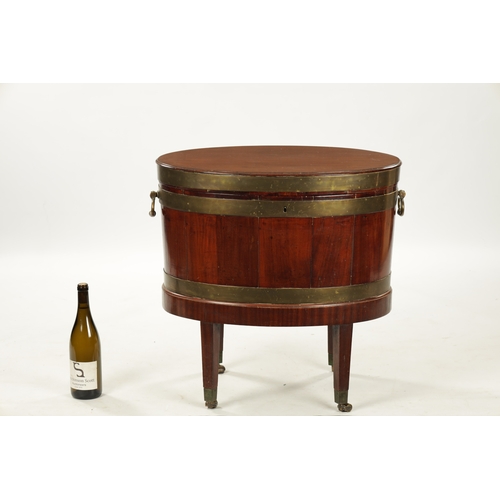 212 - A GEORGE III OVAL MAHOGANY WINE COOLER ON STAND with brass mounts and side handles; raised on taperi... 