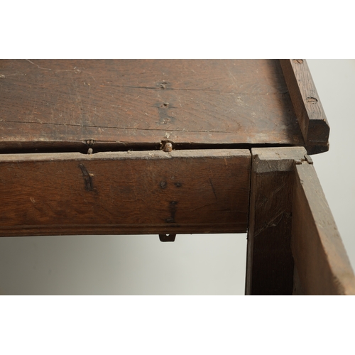 213 - A LARGE 17TH CENTURY CARVED THREE PANELLED OAK COFFER with plank top above arched leaf carved panels... 