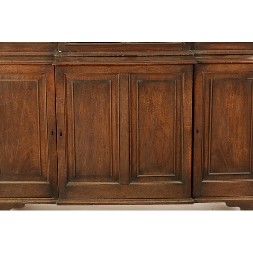 218 - A RARE SMALL SIZED GEORGE II MAHOGANY BREAKFRONT LIBRARY BOOKCASE with architectural pediment above ... 