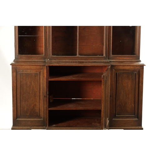 218 - A RARE SMALL SIZED GEORGE II MAHOGANY BREAKFRONT LIBRARY BOOKCASE with architectural pediment above ... 