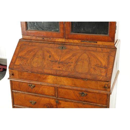 219 - AN EARLY 18TH CENTURY FIGURED WALNUT AND OAK BREAK ARCHED TOP BUREAU BOOKCASE the double arched mirr... 