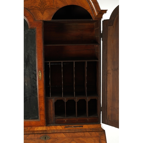 219 - AN EARLY 18TH CENTURY FIGURED WALNUT AND OAK BREAK ARCHED TOP BUREAU BOOKCASE the double arched mirr... 