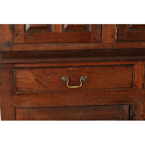 224 - AN EARLY 18TH CENTURY PANELLED OAK DUDARN with fielded panelled doors and frieze drawers (139cm wide... 