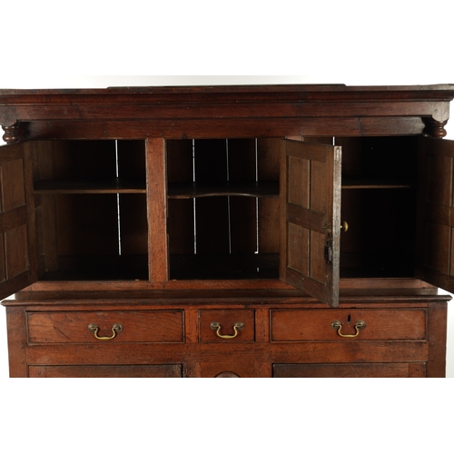 224 - AN EARLY 18TH CENTURY PANELLED OAK DUDARN with fielded panelled doors and frieze drawers (139cm wide... 