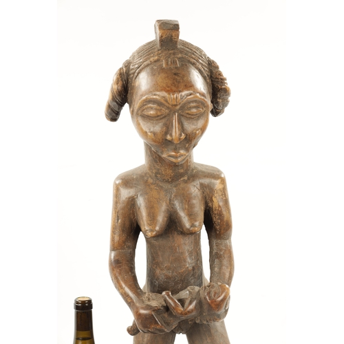 238 - AN ANTIQUE NATIVE CARVED HARDWOOD FIGURE OF LADY WITH CHILD (72cm high)