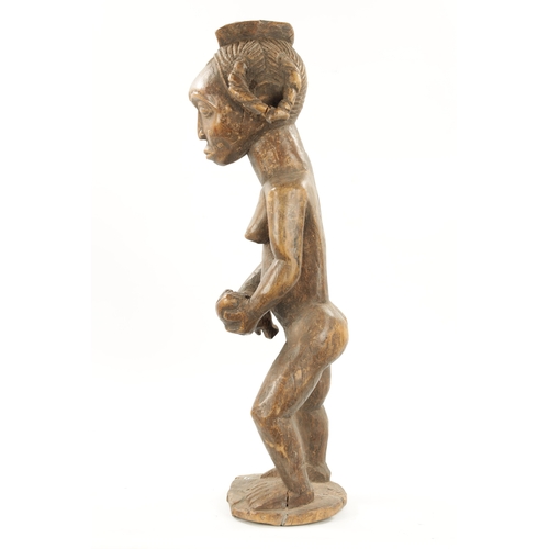 238 - AN ANTIQUE NATIVE CARVED HARDWOOD FIGURE OF LADY WITH CHILD (72cm high)