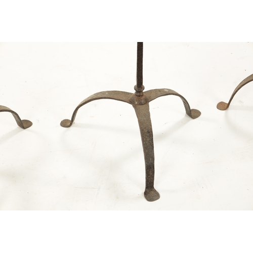 241 - A SET OF FOUR IRONWORK CHURCH FLOOR STANDING CANDLESTICKS with knopped stems and tripod bases (115cm... 