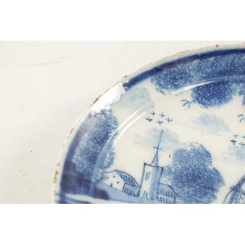 245 - AN EARLY 18TH CENTURY DELFT BLUE AND WHITE PLATE with figures and church to the back ground. (23cm d... 