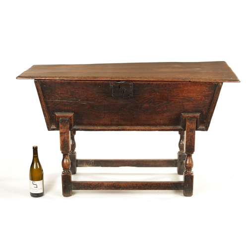 250 - AN EARLY 18TH CENTURY ELM AND OAK DOUGH BIN with lift off top; raised on a turned base. (122cm wide ... 