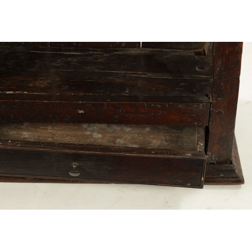 256 - A 17TH CENTURY OAK HANGING OPEN SPICE RACK WITH FITTED DRAWER (60cm wide 26cm deep 92cm high)