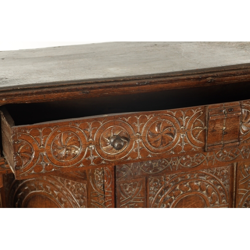 257 - A 17TH CENTURY CARVED OAK BUFFET with top drawer above an angled cupboard and open base. (119cm wide... 