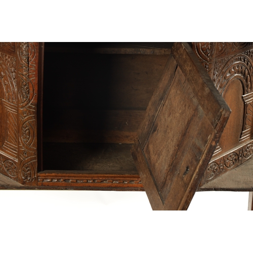 257 - A 17TH CENTURY CARVED OAK BUFFET with top drawer above an angled cupboard and open base. (119cm wide... 