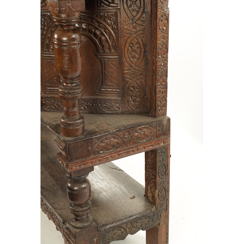 257 - A 17TH CENTURY CARVED OAK BUFFET with top drawer above an angled cupboard and open base. (119cm wide... 