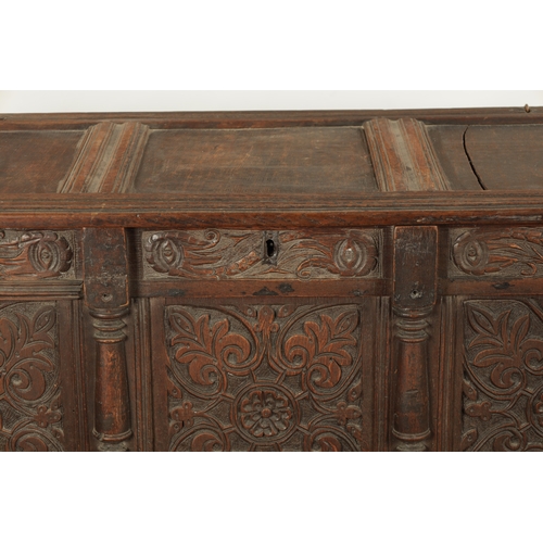 261 - A 17TH CENTURY CARVED OAK THREE PANELLED FRONT COFFER with panelled top and stile feet (141cm wide 6... 