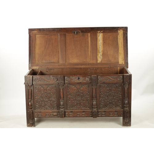 261 - A 17TH CENTURY CARVED OAK THREE PANELLED FRONT COFFER with panelled top and stile feet (141cm wide 6... 