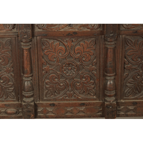 261 - A 17TH CENTURY CARVED OAK THREE PANELLED FRONT COFFER with panelled top and stile feet (141cm wide 6... 