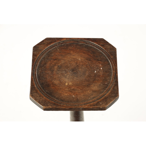 265 - AN EARLY 18TH CENTURY OAK CANDLE STAND WITH DISHED TOP with turned stem and shaped platform base (67... 