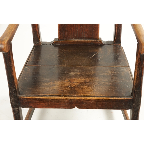 276 - AN 18TH CENTURY PRIMITIVE ASH AND ELM COUNTRY ARMCHAIR with solid shaped back splat and plank seat. ... 