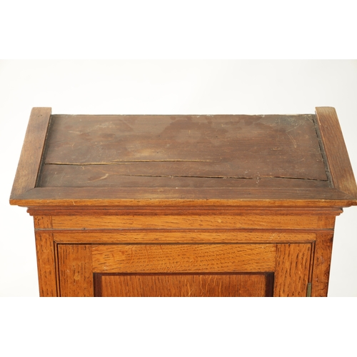 279 - AN EARLY 19TH CENTURY OAK TABLE CABINET with hinged doors revealing shelves and small drawers (43cm ... 