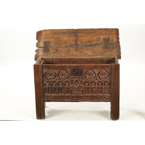 28 - A RARE 15TH/16TH CENTURY GOTHIC OAK PLANK COFFER OF SMALL SIZE with fret cut carved front (80cm wide... 