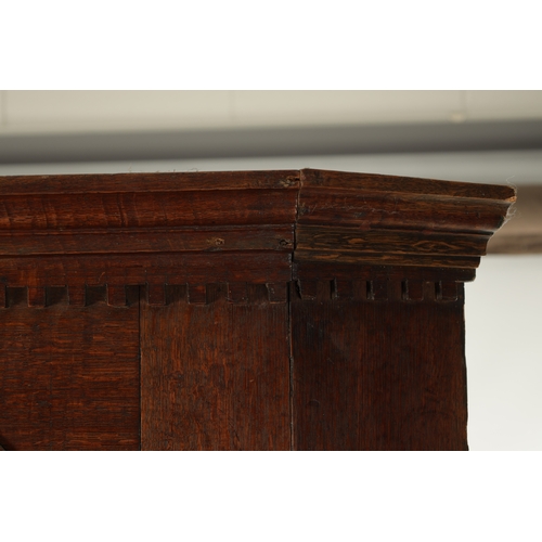 282 - AN EARLY 18TH CENTURY OAK STANDING CORNER CUPBOARD with arched top doors and pull out slide. (108cm ... 