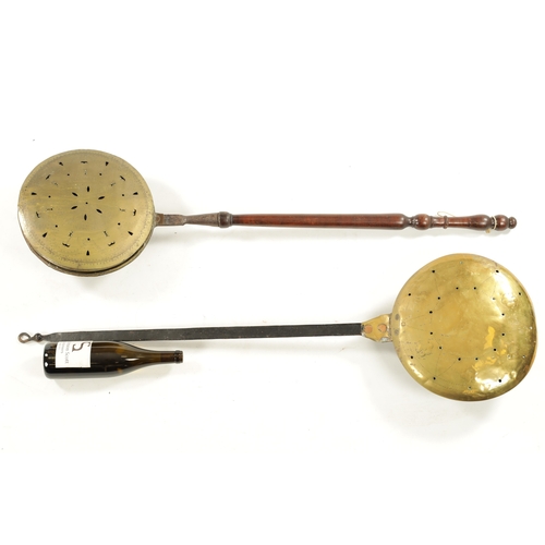 284 - A 17TH CENTURY BRASS WARMING PAN AND AN 18TH CENTURY BRASS PIERCED WARMING PAN one with an iron hand... 