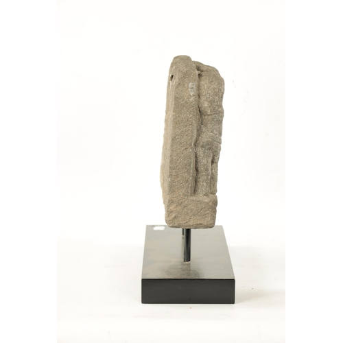 287 - A 13TH 14TH CENTURY EASTERN VOLCANIC STONE FRAGMENT mounted on a later wooden base (38cm wide 39cm h... 