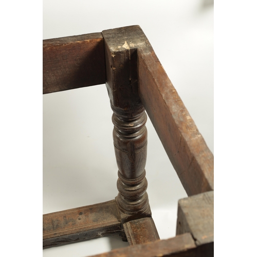 292 - A 17TH CENTURY OAK REFECTORY TABLE with carved frieze and raised on baluster legs joined by under st... 