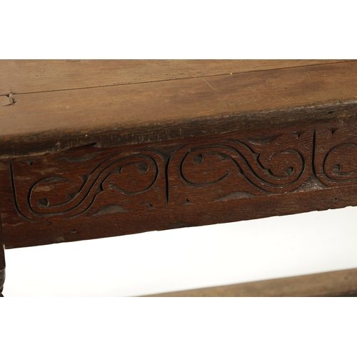 292 - A 17TH CENTURY OAK REFECTORY TABLE with carved frieze and raised on baluster legs joined by under st... 