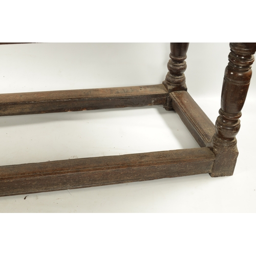 292 - A 17TH CENTURY OAK REFECTORY TABLE with carved frieze and raised on baluster legs joined by under st... 