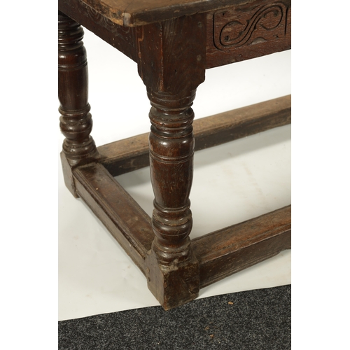 292 - A 17TH CENTURY OAK REFECTORY TABLE with carved frieze and raised on baluster legs joined by under st... 