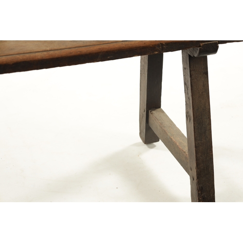 3 - AN EARLY 18TH CENTURY OAK SPINDLE BACK BENCH with plank seat; raised on splayed legs (289cm long 92c... 