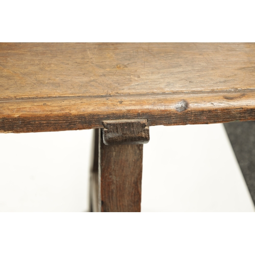 3 - AN EARLY 18TH CENTURY OAK SPINDLE BACK BENCH with plank seat; raised on splayed legs (289cm long 92c... 