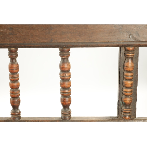 3 - AN EARLY 18TH CENTURY OAK SPINDLE BACK BENCH with plank seat; raised on splayed legs (289cm long 92c... 