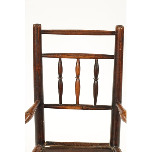 300 - A 19TH CENTURY ELM CHILD'S SPINDLE BACK ROCKING CHAIR with solid seat (70cm high 42cm wide)