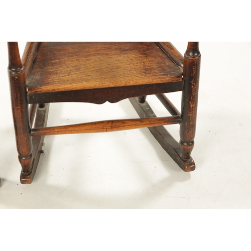 300 - A 19TH CENTURY ELM CHILD'S SPINDLE BACK ROCKING CHAIR with solid seat (70cm high 42cm wide)