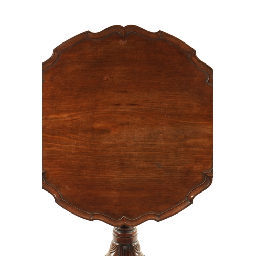 304 - AN 18TH CENTURY FIGURED MAHOGANY PIE CRUST TRIPOD TABLE ON MANX FEET with a turned stem and ribbon c... 